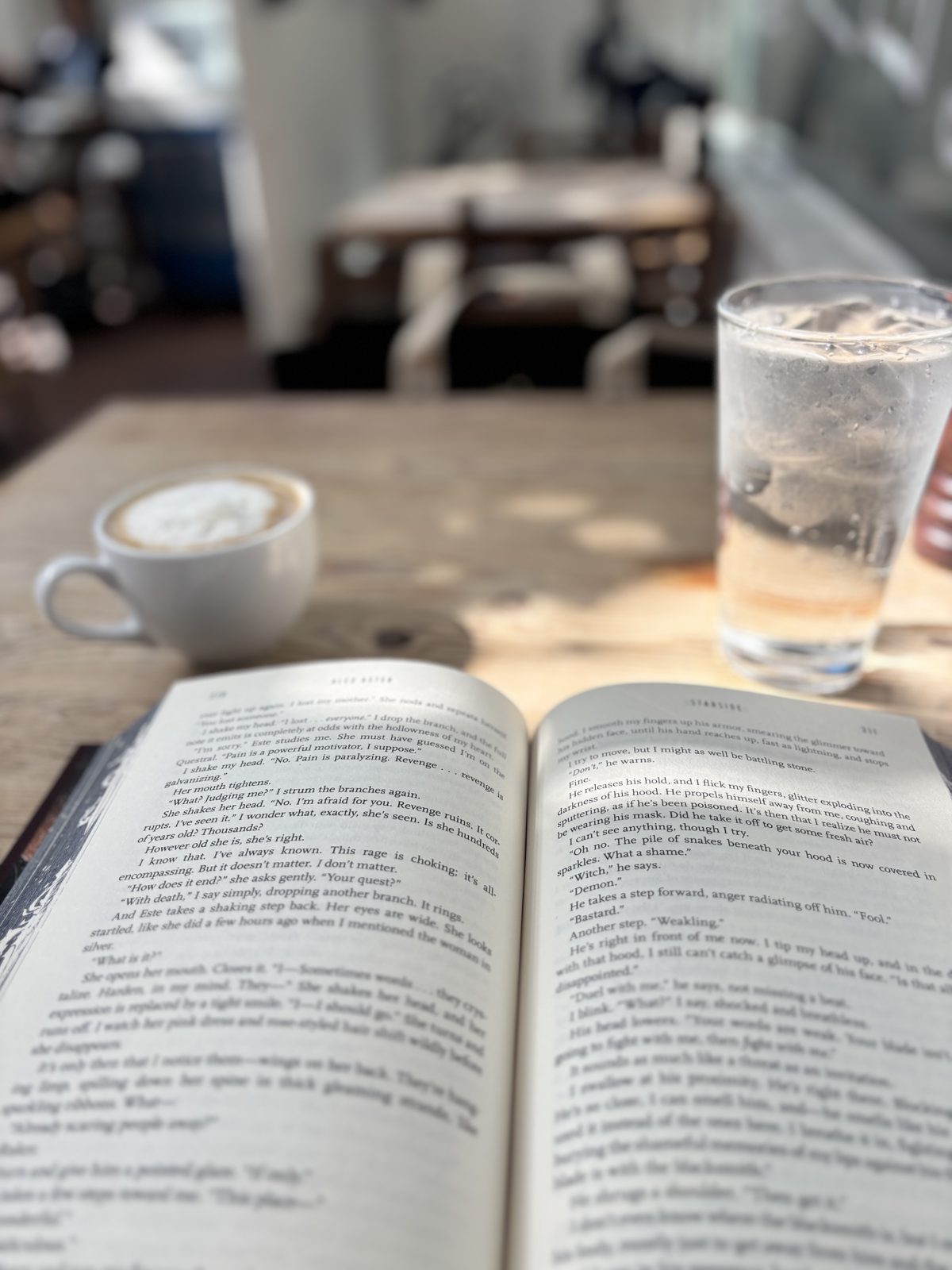 A book and coffee on a quiet café table